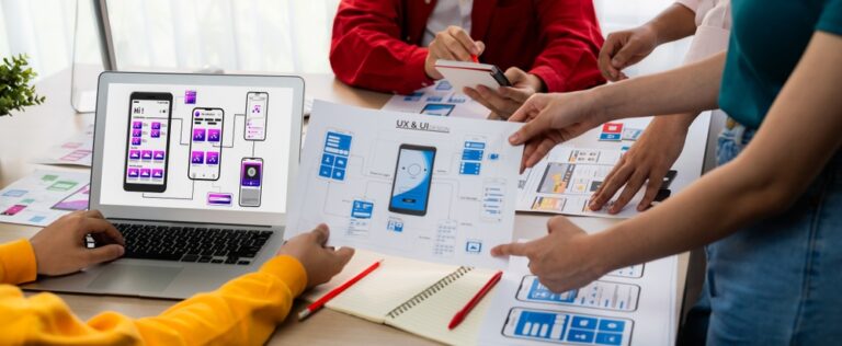 UI UX for mobile applications is shown in paper and laptop